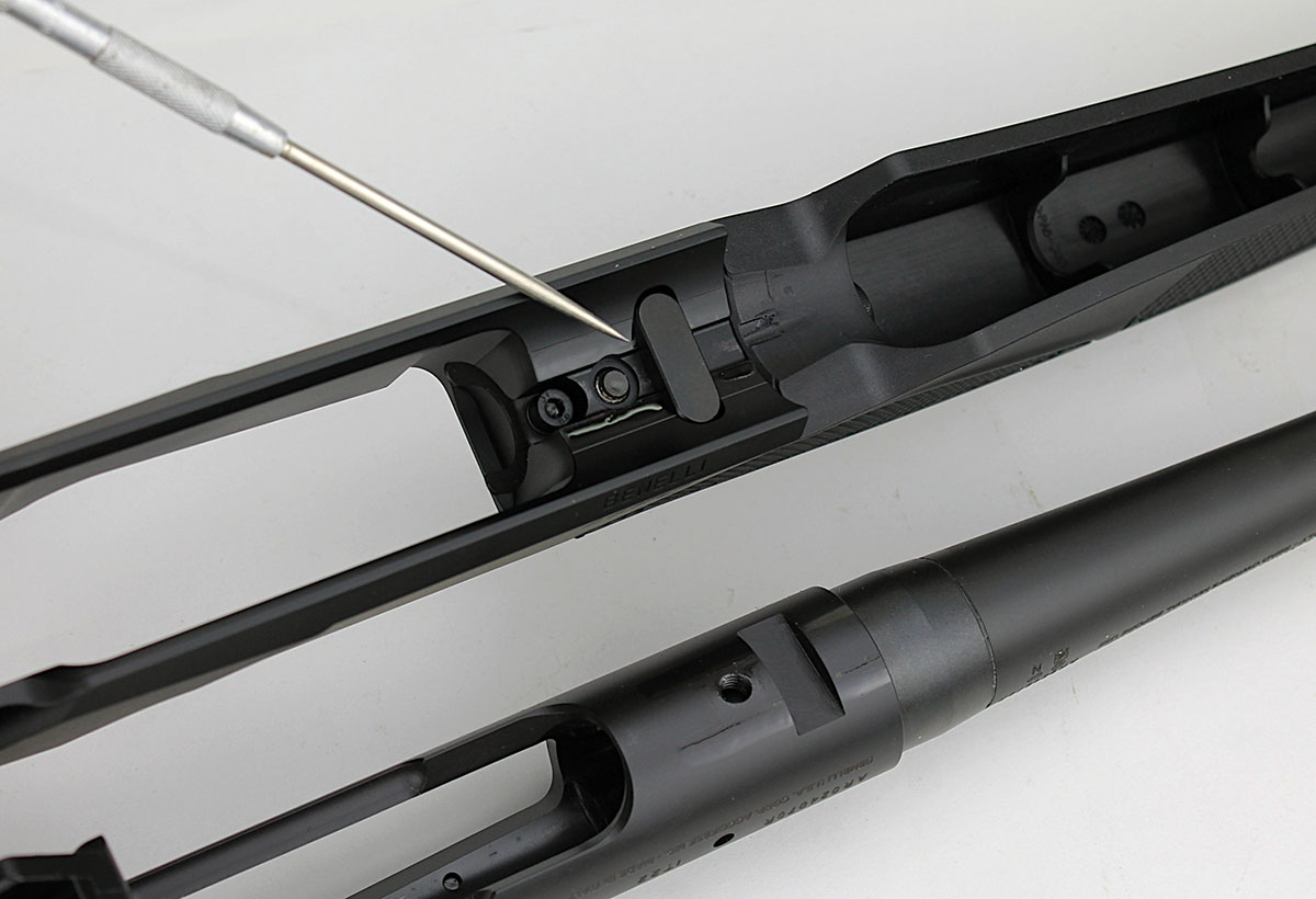 For bedding the action, a recess in the receiver mates with a transverse steel bar integral to the barrel extension.